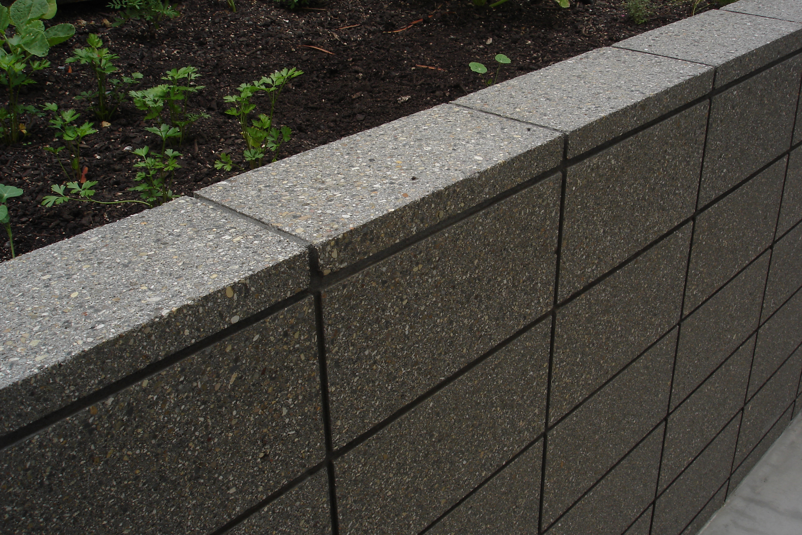 Honed Grey Coloured Masonry Retaining Wall Sealed In a Wet Look Sealer